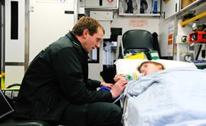 Staff with patient in ambulance