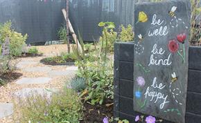 'Be well, Be kind, Be happy' entrance sign to Longwater Wellbeing Garden