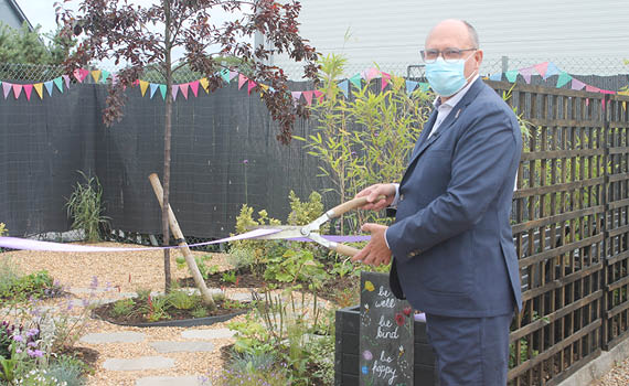 Neville Hounsome cutting the ribbon to officially open Longwater Wellbeing Garden