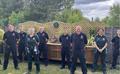 Firefighters and EEAST staff at the unveiling of the memorial garden at Luton