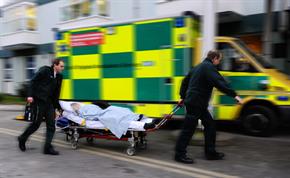 Staff with patient on stretcher at accident and emergency